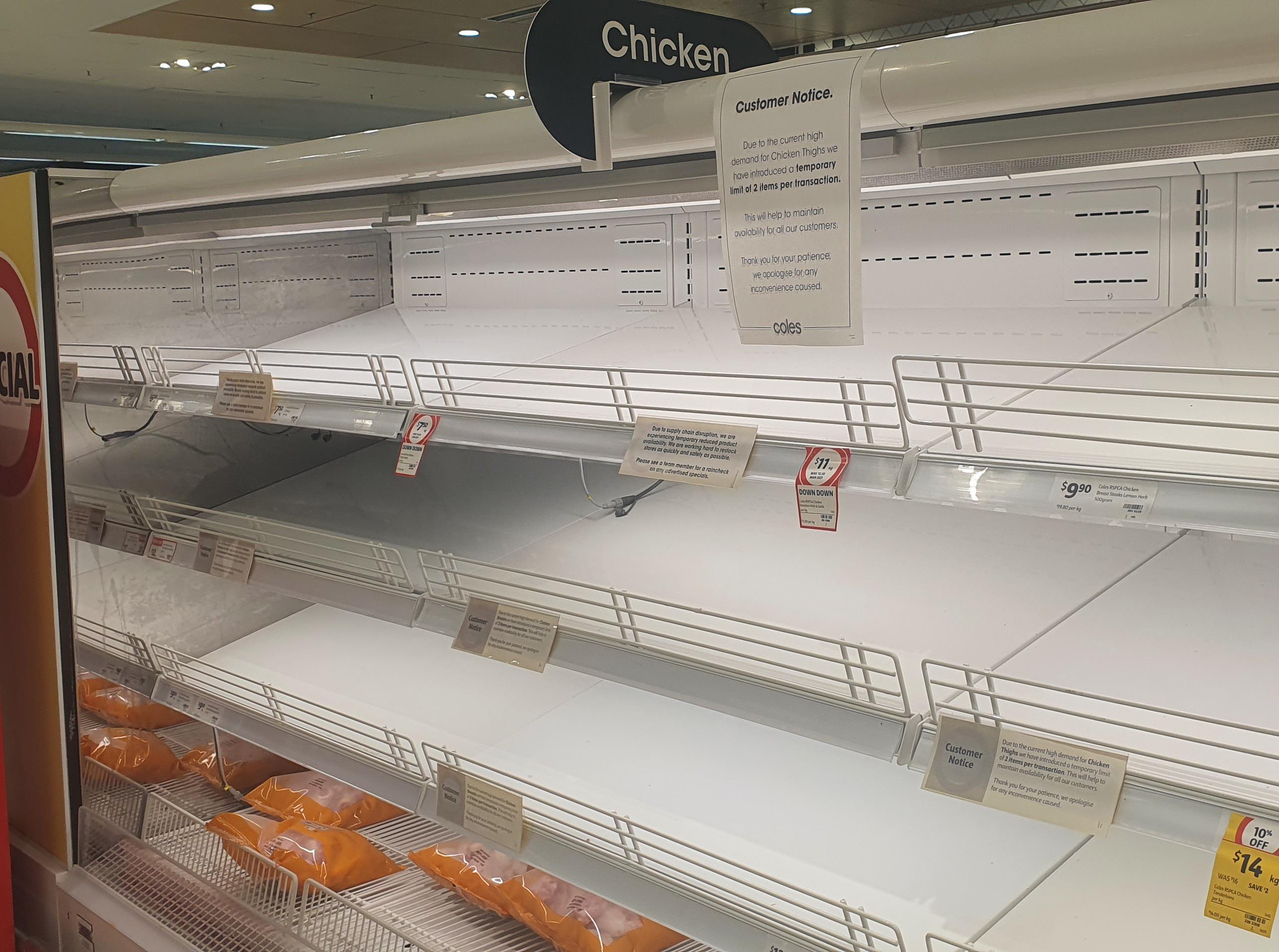 Empty supermarket shelves in the chicken section.