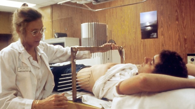 A nurse prepares a patient for radiation therapy