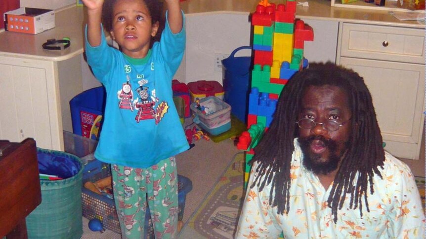 Munyaradzi Gwisai, law lecturer in Zimbabwe, (sitting) and his son (standing) in a bedroom