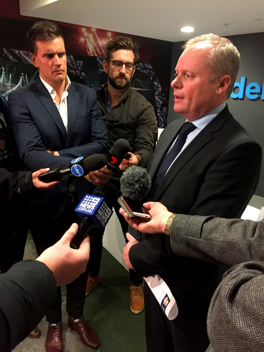 Men stand at a press conference