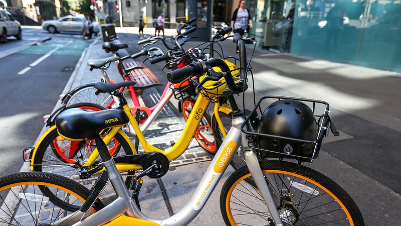 Several bikes at a bikestand.