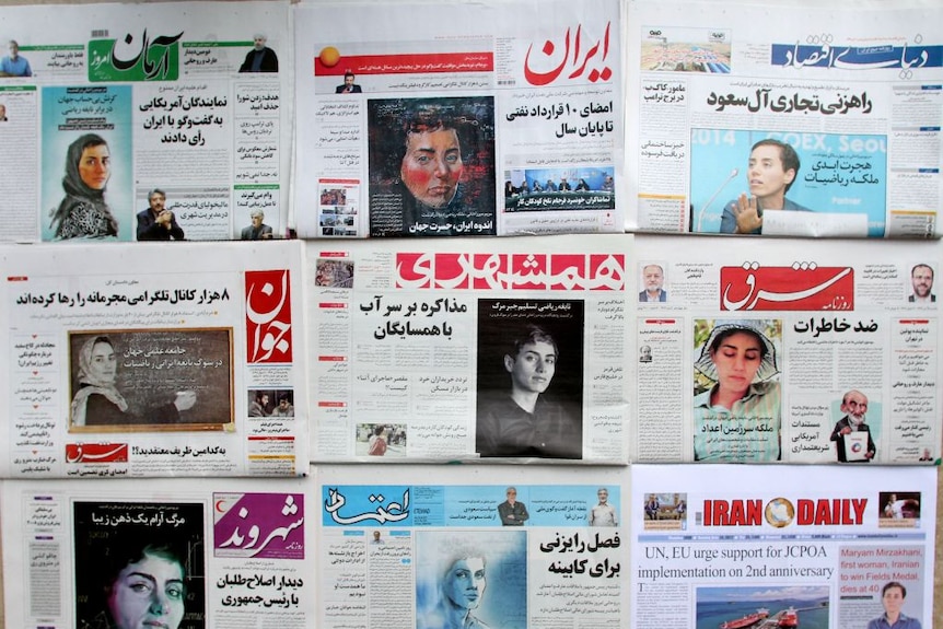Several newspapers with headlines about and images of Maryam Mirzakhani