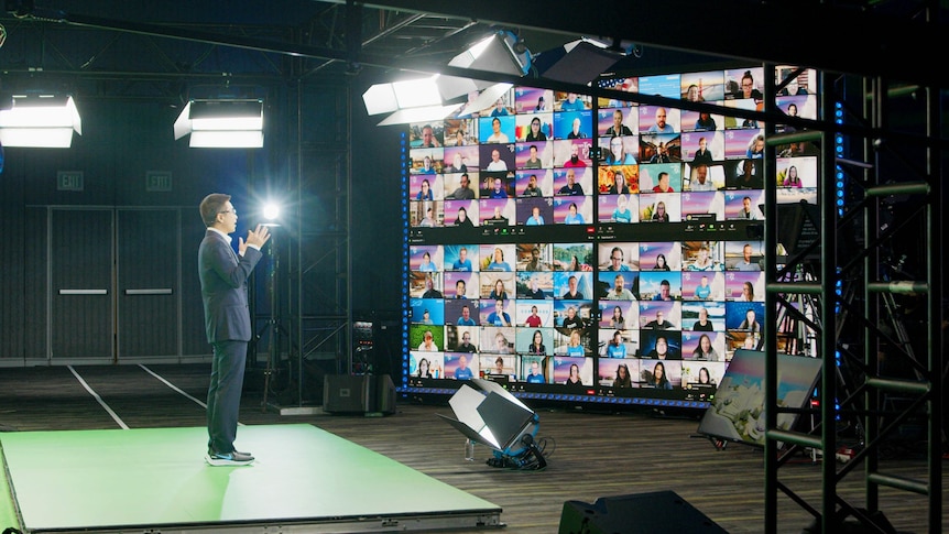 A man gives a speech to people tuning in on a Zoom meeting.