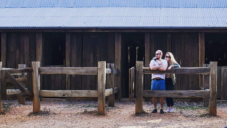 Chris and Rachel Bragg standing at a stable