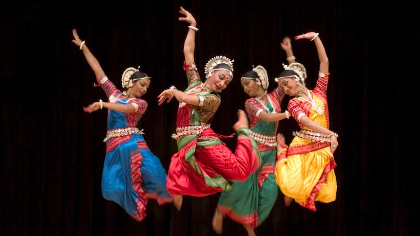 Indian dancers from the Nrityagram Dance Ensemble performing on stage.