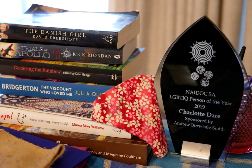 An award next to a stack of books, including The Danish Girl