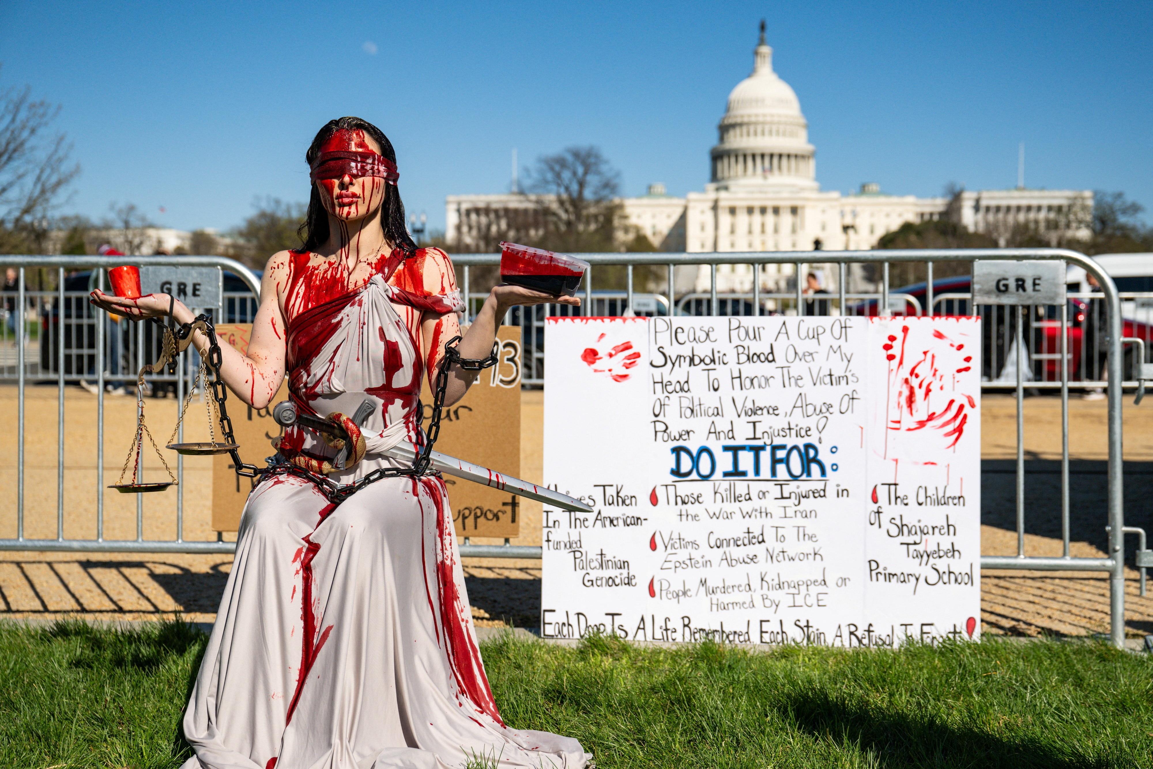 A demonstrator asking for others to pour "blood" over her in support of "victims of political violence".