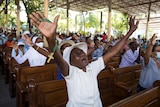 Believers pray with hands in the air against the epidemic of kidnappings in Haiti, in this April 2021 photo.