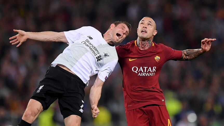 Roma's Radja Nainggolan competes for the ball with Liverpool's James Milner during a Champions League fixture