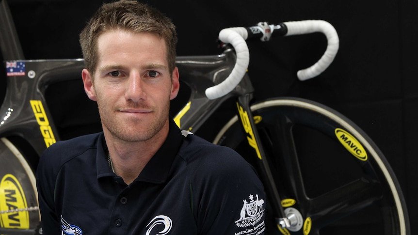 Bendigo raised cyclist Glenn O'Shea sitting in front of his bike.