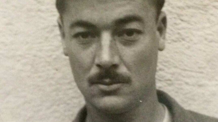 Black-and-white portrait of World War II veteran Bill Rudd, who has combed over hair and a moustache.