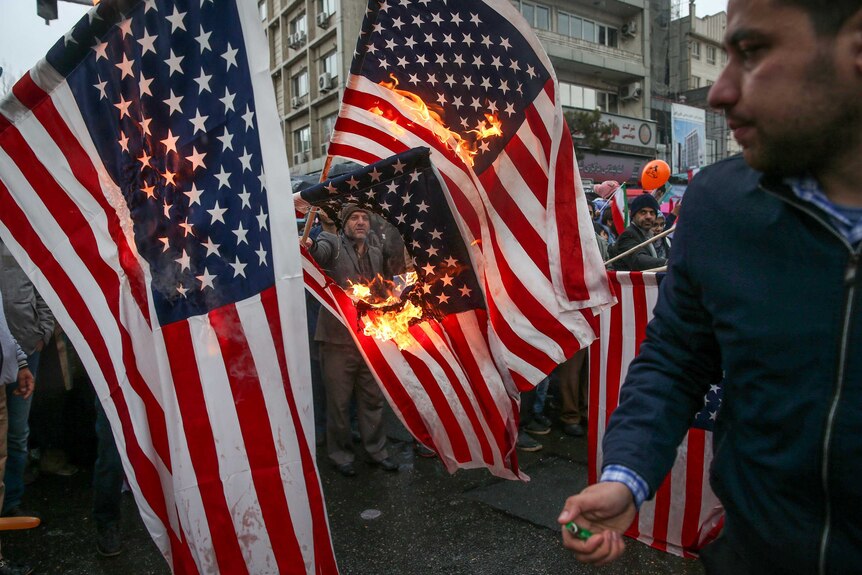 Iranian protesters burn US flag in Tehran