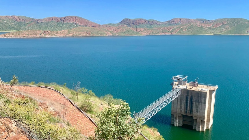 A picture of a large lake with hills in the background