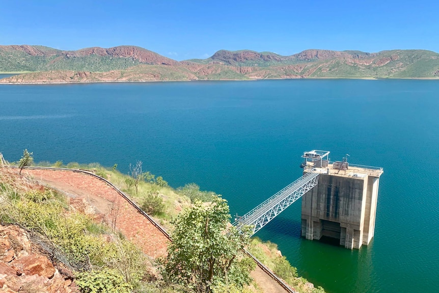 A picture of a large lake with hills in the background