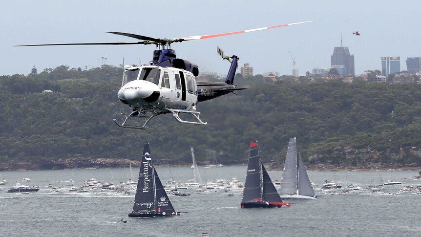 A helicopter flies over the fleet during the start of the 2015 Sydney to Hobart.