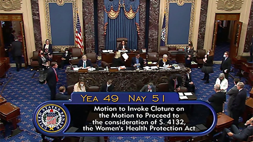 TV screen view of US Senate floor during vote with tally onscreen.