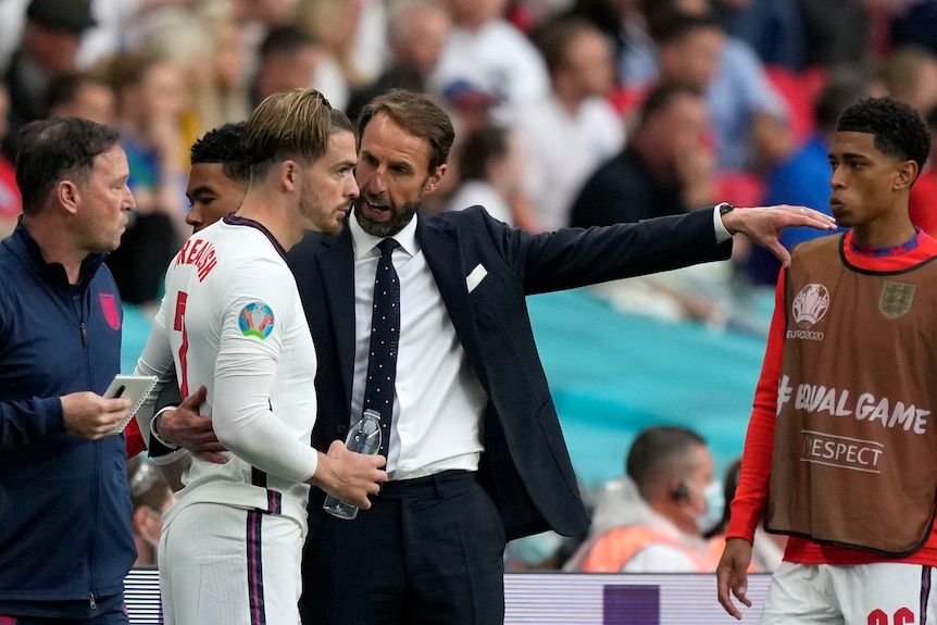 Gareth Southgate points as Jack Grealish stands next to him