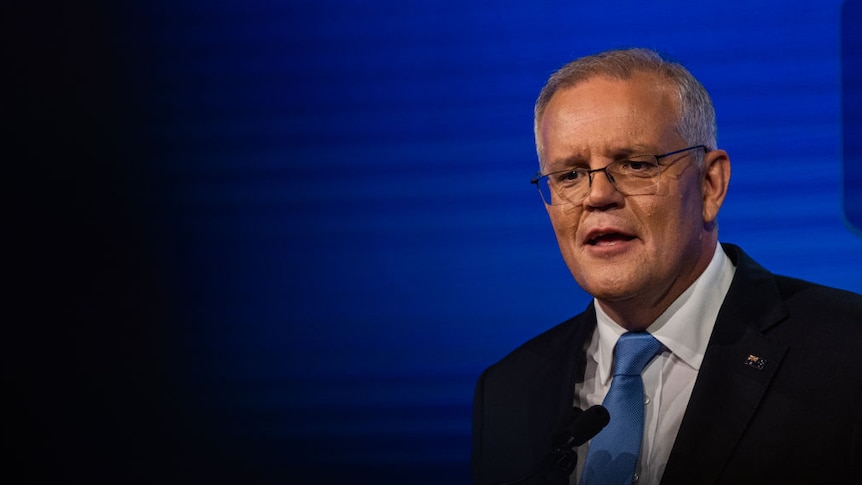 Scott Morrison with a blue background and an ominous black cloud floating to his right