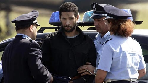 Ethiopian-born Hamdi Issac is escorted by Italian policemen during extradition to Britain to face terrorism charges.