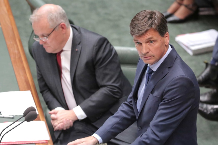 Angus Taylor speaks at the despatch box with Scott Morrison sitting behind him