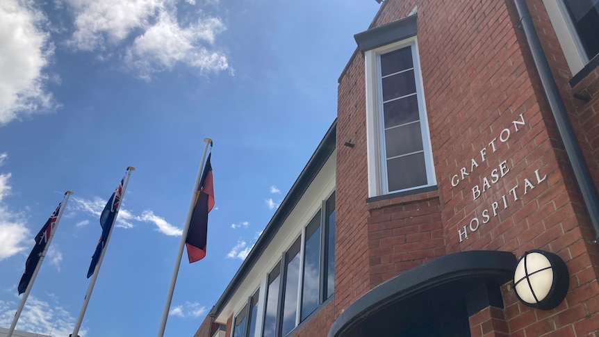 Brick hospital with sign Grafton Base Hospital and flags flying 