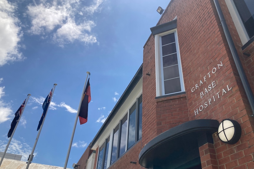 Brick hospital with sign Grafton Base Hospital and flags flying 