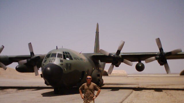 Derek Pyrah stands in front of Royal Australian Air Force plane during his deployment in the Middle East, 2003