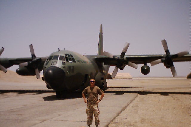 Derek Pyrah stands in front of Royal Australian Air Force plane during his deployment in the Middle East, 2003