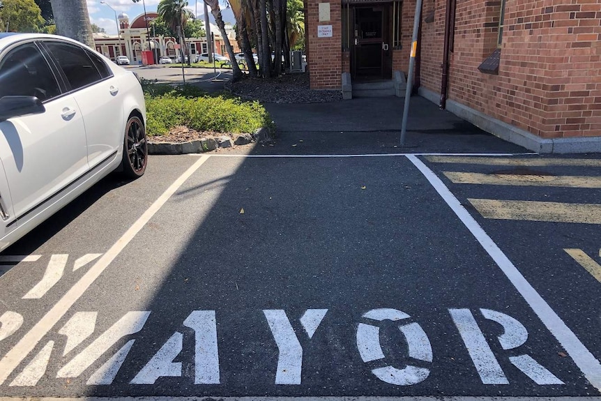 An empty car space with the word "mayor" painted on it.