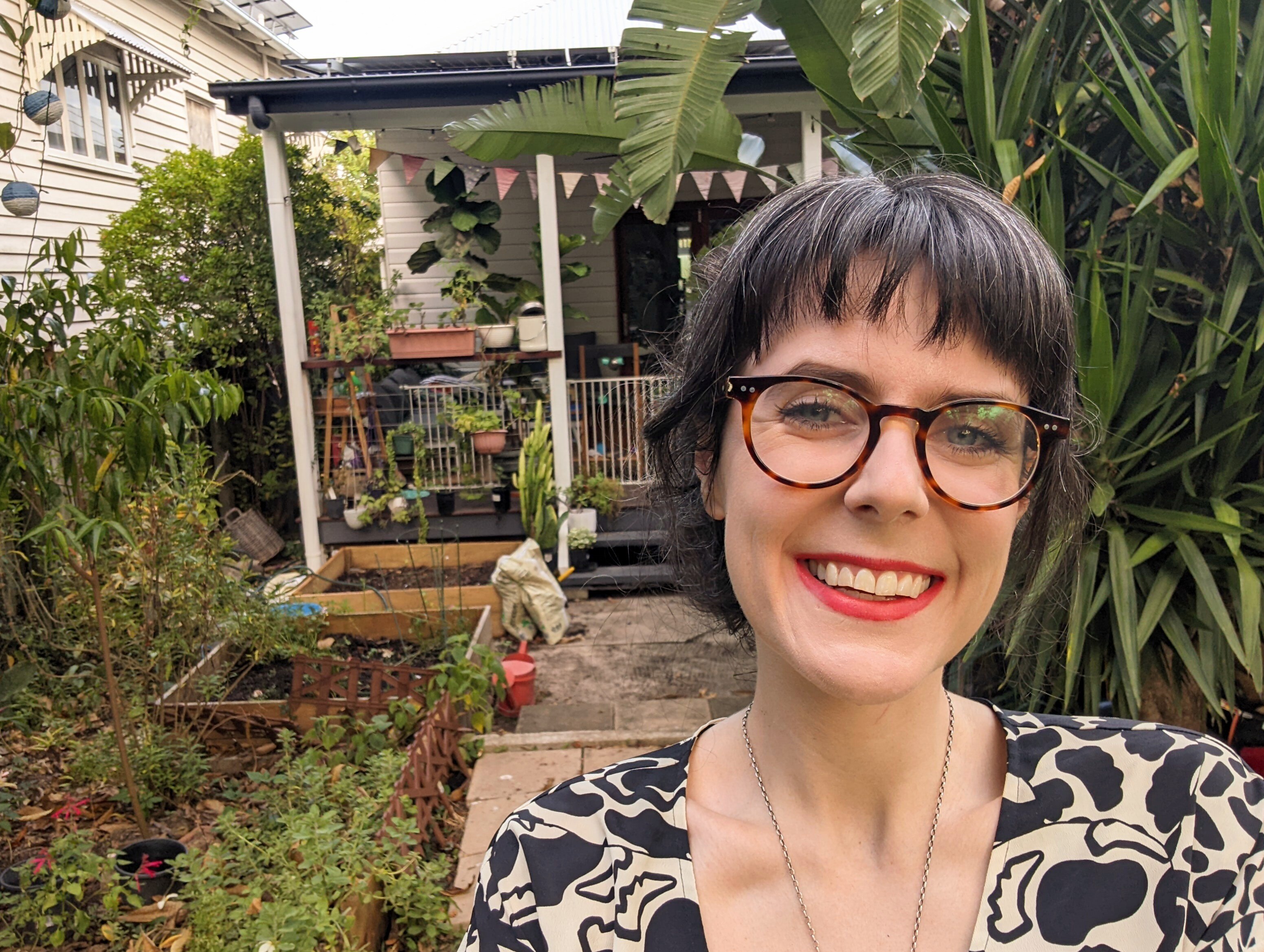 Sophie Beer stands in the backyard of her Brisbane home.