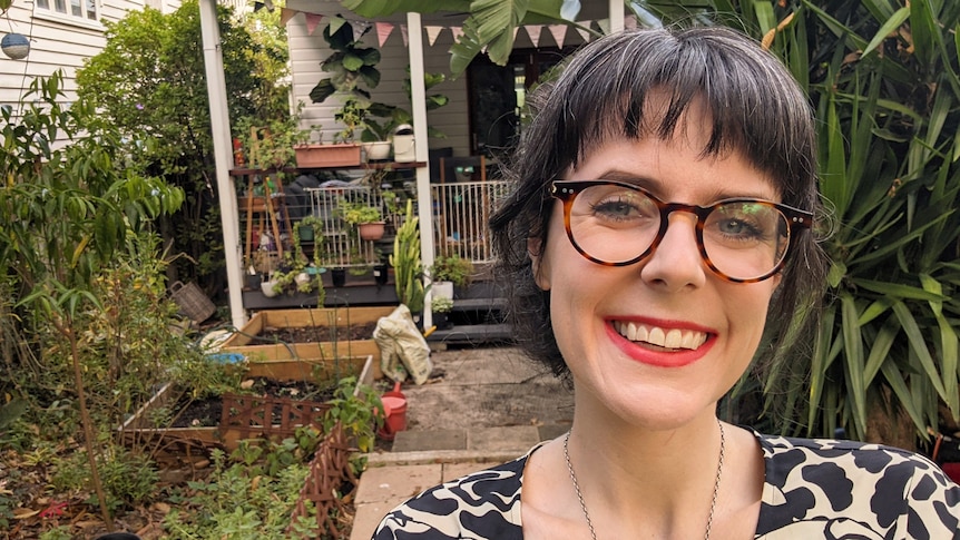 Sophie Beer stands in the backyard of her Brisbane home.