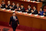 Chinese President Xi Jinping is applauded as he walks to the podium to deliver a speech in front of party members.