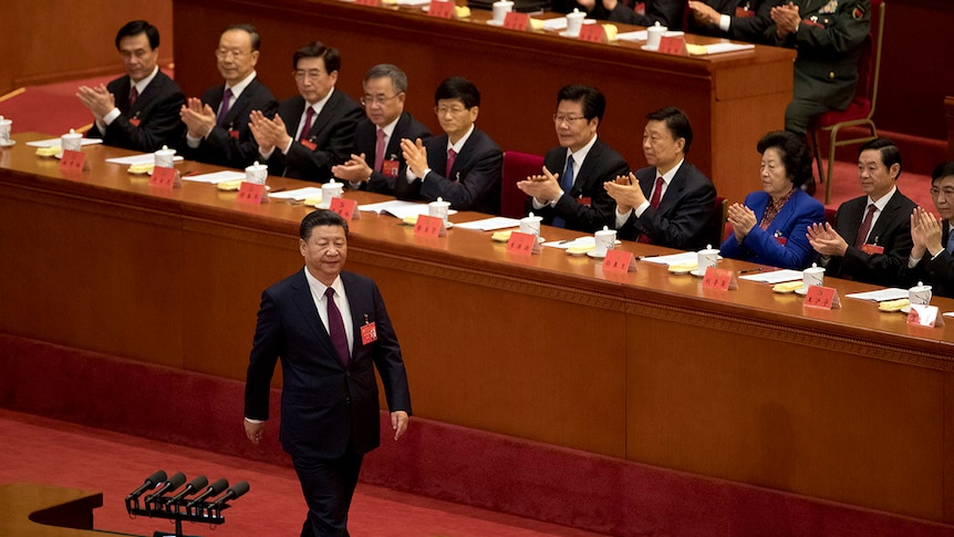 Chinese President Xi Jinping is applauded as he walks to the podium to deliver his speech.