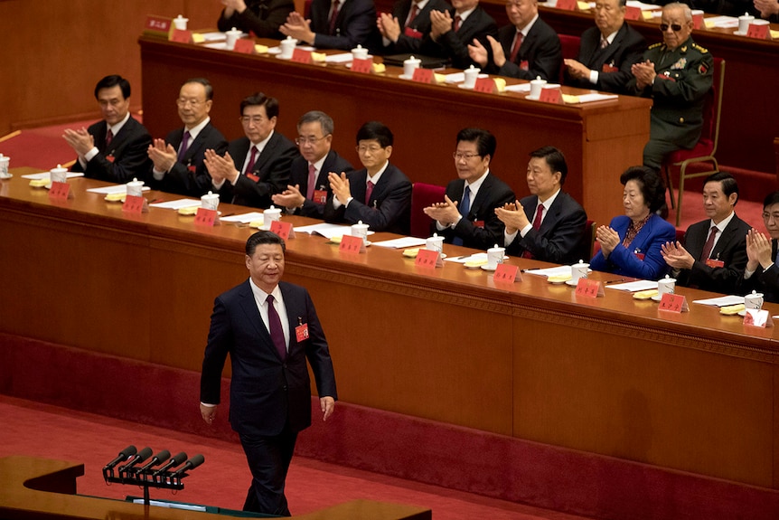 Chinese President Xi Jinping is applauded as he walks to the podium to deliver his speech.