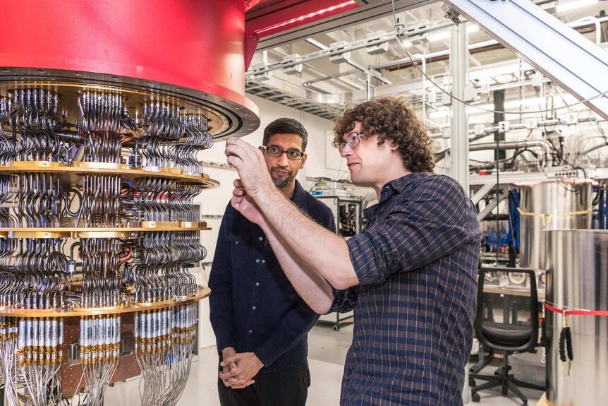 Google CEO Sundar Pichai (left) with one of Google's quantum computers