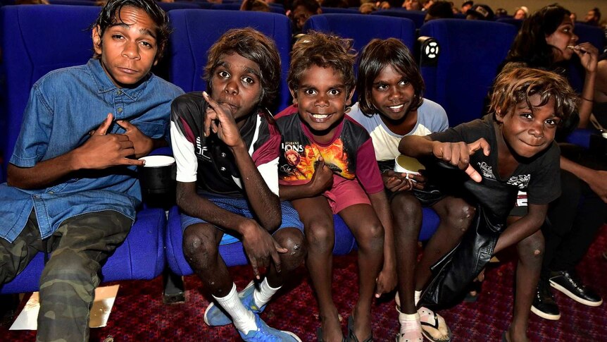 Five Indigenous kids, including actor Tremayne Doolan, in the front row of the Alice Springs cinema