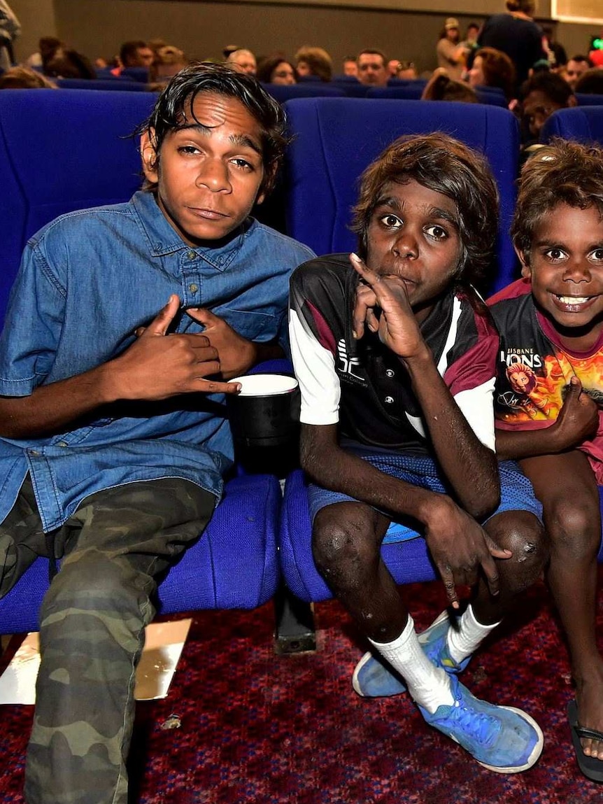 Five Indigenous kids, including actor Tremayne Doolan, in the front row of the Alice Springs cinema