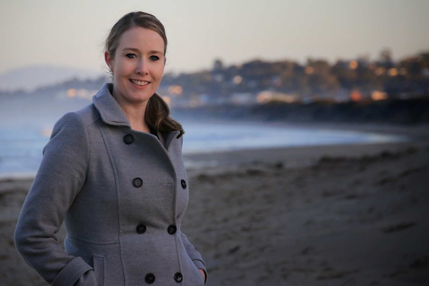 Emma Churchill poses on a beach.