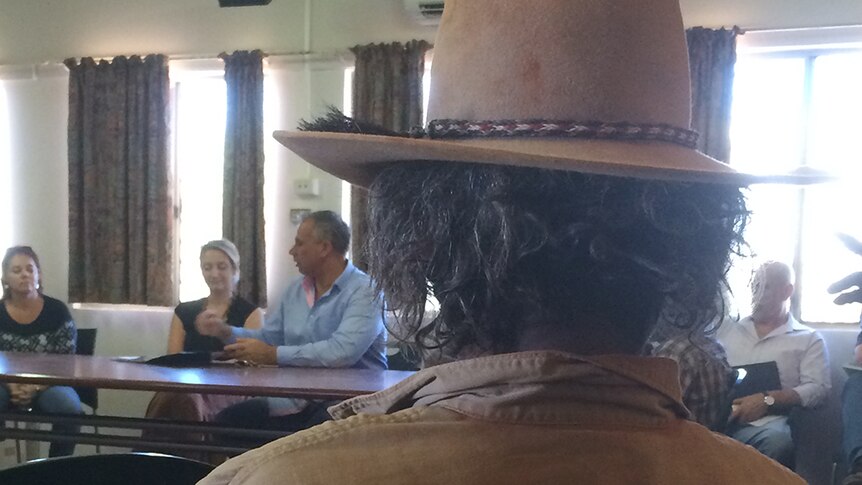 An Arlparra local [foreground] listens as Chief Minister Adam Giles addresses a public meeting.