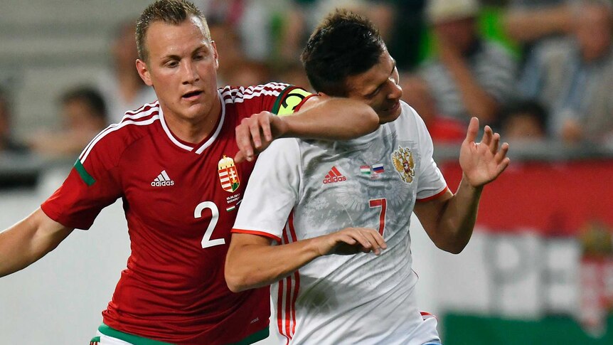 Russia's Dmitry Poloz is elbowed in the head.