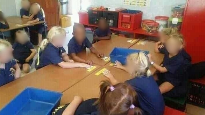 Children sitting in a classroom, faces blurred