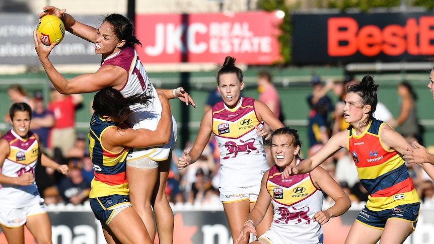 Leah Kaslar takes a mark for the Lions in their AFLW match against the Crows