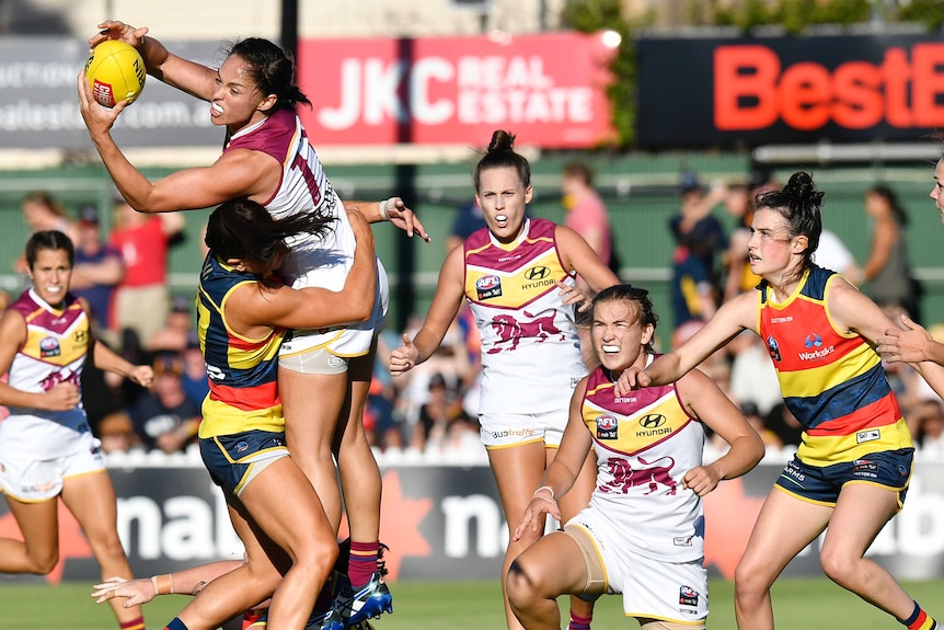 Leah Kaslar takes a mark for the Lions in their AFLW match against the Crows