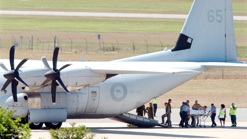 Bali bomb survivors arrive at Brisbane airport on a RAAF Hercules.
