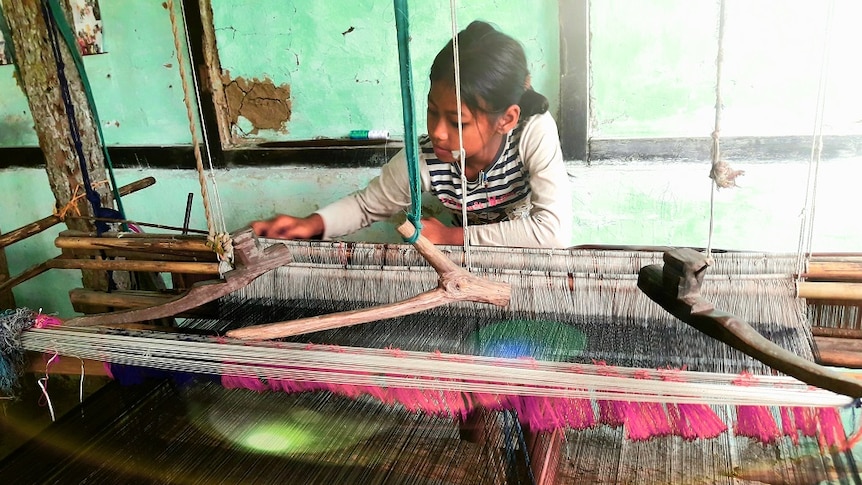 Girl Weaving Loom In Workshop
