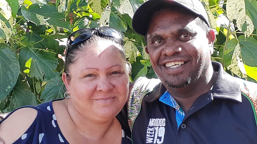 A smiling Indigenous Australian man with his wife