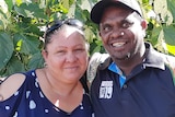A smiling Indigenous Australian man with his wife
