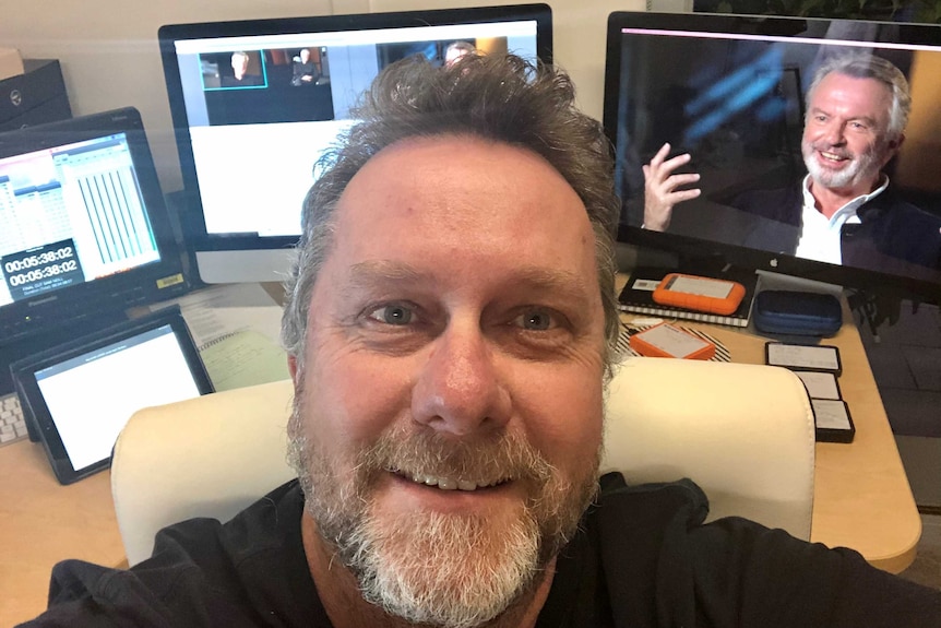 Harley selfie with computer screens in background.