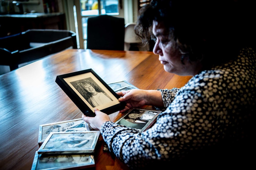 Shani holds a picture of Colleen.