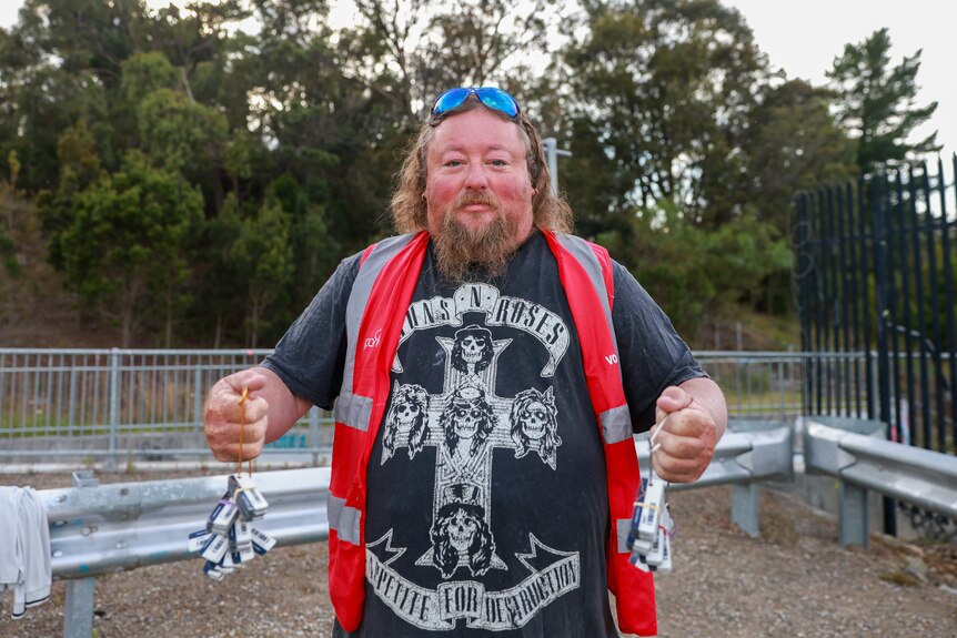 Stewart Farmer in a high vis vest holding hundreds of parkrun tags.